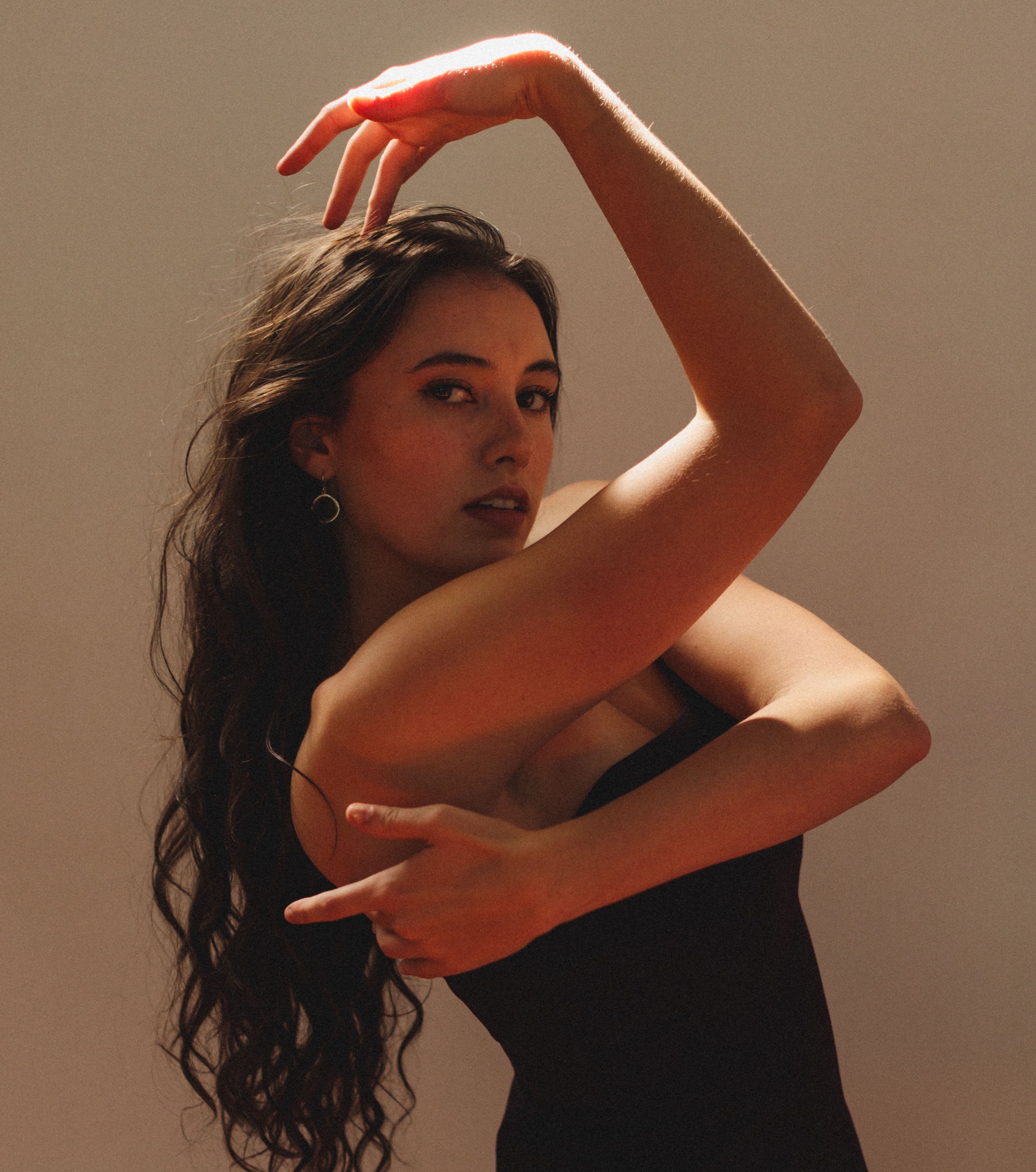 young woman with brown hair in dance pose